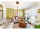 Bright living room with comfortable seating and large window at 1523 Whooping Dr, Groveland, FL 34736
