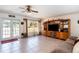 Living area with French doors opening to the backyard and built-in shelving at 1523 Whooping Dr, Groveland, FL 34736