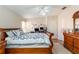 Spacious main bedroom with a dresser and large bed at 1523 Whooping Dr, Groveland, FL 34736