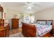 Main bedroom with wood furniture and access to the bathroom at 1523 Whooping Dr, Groveland, FL 34736