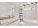 Bathroom with granite countertop, white vanity, and shower/tub combo at 2011 Begonia Way, Poinciana, FL 34759