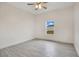 Well-lit bedroom with ceiling fan and wood-look tile floors at 2011 Begonia Way, Poinciana, FL 34759