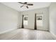 Spacious bedroom with ceiling fan and wood-look tile floor at 2011 Begonia Way, Poinciana, FL 34759