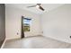 Bright bedroom featuring a ceiling fan and large window at 2011 Begonia Way, Poinciana, FL 34759