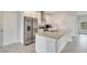 Modern kitchen with stainless steel appliances and granite island at 2011 Begonia Way, Poinciana, FL 34759
