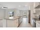 White kitchen with granite island and stainless steel appliances at 2011 Begonia Way, Poinciana, FL 34759