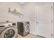 Laundry room with washer, dryer, and overhead shelving at 2011 Begonia Way, Poinciana, FL 34759