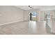 Living room with tile floors and sliding glass doors to backyard at 2011 Begonia Way, Poinciana, FL 34759