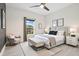 Serene main bedroom with a plush, upholstered bed, decorative pillows, and calming neutral color palette at 2011 Begonia Way, Poinciana, FL 34759