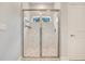 Modern shower with frameless glass enclosure and marble tile at 2011 Begonia Way, Poinciana, FL 34759