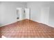 Simple bedroom with terracotta tile floors and access to a bathroom at 203 San Gabriel St, Winter Springs, FL 32708