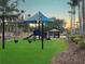 Community playground with swings, slide, and covered picnic area provides fun outdoor space at 234 Paloma Dr, Davenport, FL 33837