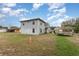Expansive backyard featuring a grassy area, trampoline, and view of the two-story home, ideal for outdoor activities at 2357 Palm Way, Oviedo, FL 32765