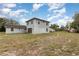 Large backyard with exterior view of the two-story home, providing ample space and showcasing outdoor amenities at 2357 Palm Way, Oviedo, FL 32765