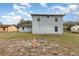 Spacious backyard with grassy area and exterior view of the two-story home, showcasing outdoor potential at 2357 Palm Way, Oviedo, FL 32765