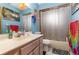 Practical bathroom with a shower-tub combo, vanity, and neutral tiling, providing essential functionality at 2357 Palm Way, Oviedo, FL 32765