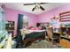 Charming bedroom featuring a ceiling fan, window for natural light, and decorative elements, creating a cozy atmosphere at 2357 Palm Way, Oviedo, FL 32765