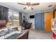 Cozy bedroom with a ceiling fan, carpeted floors, closet, and window for natural light, offering comfort and functionality at 2357 Palm Way, Oviedo, FL 32765
