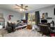 Comfortable bedroom featuring carpeted floors, a ceiling fan, a window for natural light, and playful decor at 2357 Palm Way, Oviedo, FL 32765