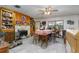 Inviting dining room with tile floors, stone fireplace, and built-in shelves at 2357 Palm Way, Oviedo, FL 32765