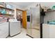 Functional laundry room with appliances, shelving, and access to other areas, enhancing household efficiency at 2357 Palm Way, Oviedo, FL 32765