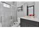 Bathroom featuring glass shower door, patterned floor tile, and wall mounted shelving at 247 Hampton Loop, Davenport, FL 33837