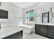 Bathroom showcasing a soaking tub, double vanity and a large window with a view at 247 Hampton Loop, Davenport, FL 33837