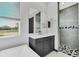 Modern bathroom featuring double vanity, walk-in shower with patterned tile and natural light at 247 Hampton Loop, Davenport, FL 33837
