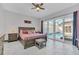 Well-lit main bedroom with a view of the pool, wood nightstands, and neutral decor at 247 Hampton Loop, Davenport, FL 33837
