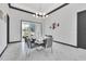 Formal dining room with a long table set for a meal and sliding glass doors to the backyard at 247 Hampton Loop, Davenport, FL 33837