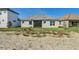 Rear exterior view of the home, showing a screened lanai and a spacious yard at 247 Hampton Loop, Davenport, FL 33837