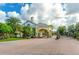 Community entrance with well-maintained landscaping and brick-paved road at 247 Hampton Loop, Davenport, FL 33837