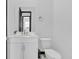 Modern half bath with white vanity, toilet, and elegant fixtures at 247 Hampton Loop, Davenport, FL 33837