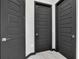 Hallway with multiple dark interior doors at 247 Hampton Loop, Davenport, FL 33837