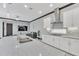 Bright kitchen with island, stainless steel appliances, and open layout into the living room at 247 Hampton Loop, Davenport, FL 33837