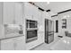 Modern white kitchen featuring stainless steel appliances, stylish cabinets, and sleek countertops at 247 Hampton Loop, Davenport, FL 33837