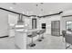 Modern white kitchen with island, stainless steel appliances, and adjacent dining area at 247 Hampton Loop, Davenport, FL 33837
