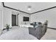 Modern living room featuring a gray stone accent wall, comfortable seating, and a contemporary design at 247 Hampton Loop, Davenport, FL 33837