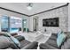 Cozy living room with a large TV, comfortable couches, and a view of the pool outside at 247 Hampton Loop, Davenport, FL 33837