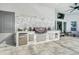 Stylish outdoor kitchen features a stainless steel grill, mini-fridge, sink and seating area at 247 Hampton Loop, Davenport, FL 33837