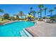 Resort-style pool with slide, tables, chairs and umbrellas at 247 Hampton Loop, Davenport, FL 33837