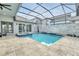 Beautiful backyard featuring a large pool, spa, patio, outdoor kitchen, and comfortable lounge furniture at 247 Hampton Loop, Davenport, FL 33837