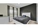 Bedroom with a queen-size bed, dark-accent wall, and ceiling fan at 3097 Pequod Pl, Kissimmee, FL 34746