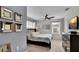 Main bedroom with a king-size bed, ceiling fan, and large TV at 3097 Pequod Pl, Kissimmee, FL 34746