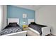 Bedroom with two twin beds and blue accent wall at 3097 Pequod Pl, Kissimmee, FL 34746