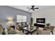 Living room featuring a sectional sofa, coffee table, and large TV at 3097 Pequod Pl, Kissimmee, FL 34746
