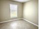 Well-lit bedroom featuring window blinds and tile floors at 333 E Church St, Deland, FL 32724