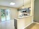 Modern kitchen with gray cabinets and granite countertop, view of backyard at 333 E Church St, Deland, FL 32724