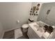 Clean bathroom with white vanity, toilet, and decorative wall art at 4390 Bull St, St Cloud, FL 34772
