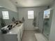 Clean bathroom with double sinks and a shower at 4390 Bull St, St Cloud, FL 34772